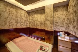 a bedroom with a bed and a wooden wall at Orchid Hotel Al Barsha "Formerly Golden Tulip Hotel Al Barsha" in Dubai