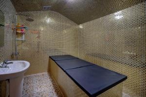 a tiled bathroom with a sink and a toilet at Orchid Hotel Al Barsha "Formerly Golden Tulip Hotel Al Barsha" in Dubai