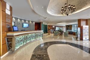 a lobby with a bar in a hotel at Golden Tulip Hotel Al Barsha in Dubai