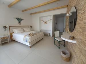 Posteľ alebo postele v izbe v ubytovaní Notus Suites