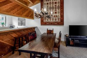 a dining room with a wooden table and a tv at Gold Bend 5034 in Truckee