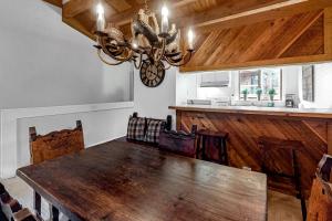 a dining room with a wooden table and a chandelier at Gold Bend 5034 in Truckee