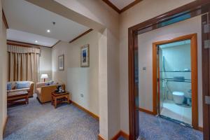 a hotel room with a suite with a bathroom at Orchid Hotel Al Barsha "Formerly Golden Tulip Hotel Al Barsha" in Dubai