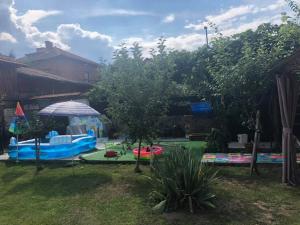 a garden with a playground and an umbrella at Michel Hotel in Bansko