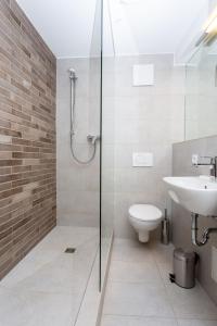 a bathroom with a shower and a toilet and a sink at limehome Montabaur Kirchstraße in Montabaur
