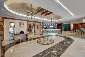 a large lobby with a dining room and a bar at Orchid Hotel Al Barsha "Formerly Golden Tulip Hotel Al Barsha" in Dubai