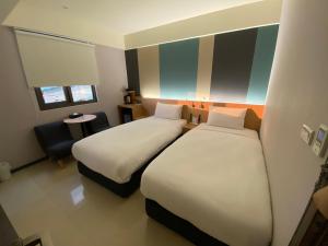 Voodi või voodid majutusasutuse Fu Kuang Hotel toas