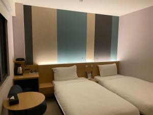 Voodi või voodid majutusasutuse Fu Kuang Hotel toas