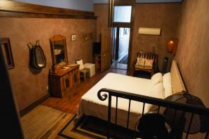 a bedroom with a bed and a desk and a mirror at Bisbee Grand Hotel in Bisbee