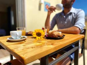 a man sitting at a table with a plate of food at Borghetto Hotel in Santa Marinella