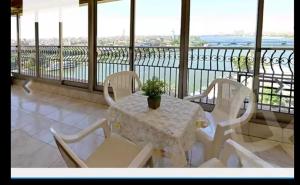 a white table and chairs on a balcony at Omar Apartment in Cairo