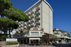 a large white building on a city street at Hotel Concord in Riccione