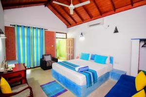 1 dormitorio con 1 cama y sillas en una habitación en Randoni Villa, en Raddoluwa