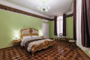 a bedroom with a large bed with green walls and a chandelier at Simon’ Secret in Venice