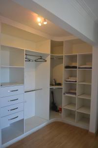 a large white closet with white shelves at Apartamento Inteiro com Vista do Lago Quitandinha in Petrópolis