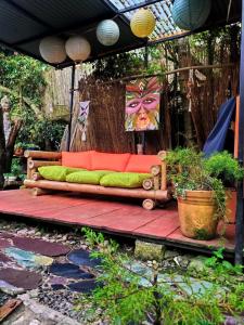 a wooden bench sitting on a wooden deck with a painting at Cabañas Sinduly Bed & Breakfast in Sopó