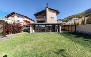 a house with a large lawn in front of it at Villa Koko Hills in Sapareva Banya