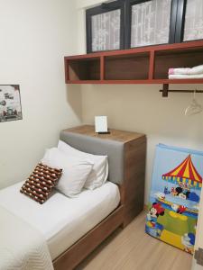 a small bedroom with a bed and a toy tent at TIMURBAY by Fifth'D STUDIO in Kampung Sungai Karang