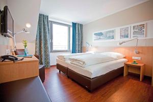 Postel nebo postele na pokoji v ubytování Sebcity Hotel