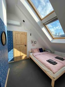 een slaapkamer met een bed en een dakraam bij Apartament Stara Praga 1 in Warschau