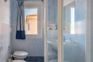 a bathroom with a toilet and a sink at Baia de Bahas Residence in Golfo Aranci