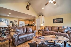 a living room with leather couches and a table at Hiawassee Cabin with Mtn Views Less Than 1 Mi to Lake! in Hiawassee