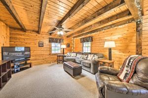 a living room with leather couches and a flat screen tv at All-Season Sanctuary Steps to Moosehead Lake in Greenville