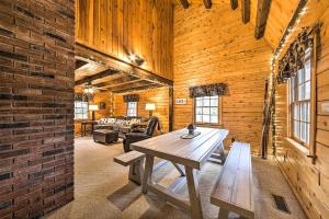 a living room with a table and a brick wall at All-Season Sanctuary Steps to Moosehead Lake in Greenville