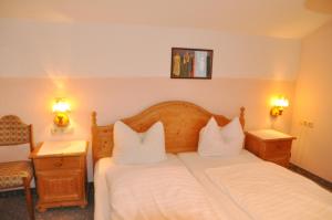 a hotel room with a bed with two white pillows at Landgasthof Venushof in Bad Griesbach