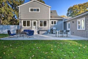 a patio with chairs and a table in front of a house at Rochester House with Fire Pit, Grill and Patio! in Rochester