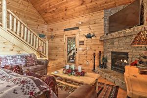 a living room with a fireplace in a log cabin at Woodsy Retreat with Hot Tub, 8 Mi to Dollywood! in Sevierville