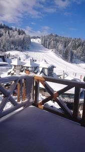 a view of a snow covered mountain with a fence at Vučko Apartman U532 in Jahorina