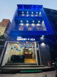 a store front with a blue awning on a building at The Century Plaza Hotel in Varanasi