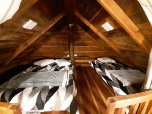 a room with two beds in a attic at POUSADA CABANA TIO ZEZO in Esteves Júnior