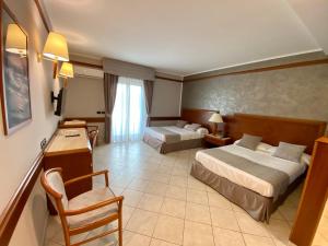 Postel nebo postele na pokoji v ubytování Hotel Le Palme