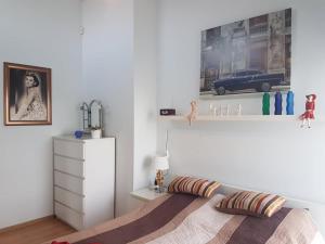 a bedroom with a bed and a picture on the wall at Apartament Nina in Skoczów