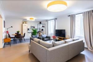 a living room with a couch and a table at Experience Central Vienna from a Stylish and Modern Apartment in Vienna