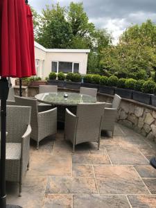 a patio with a table and chairs on a patio at The Hawthornes Licensed Guest House in Knottingly