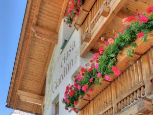 a building with flowers on the side of it at Residence Ciasa Giardun in La Villa