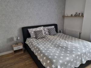 a bedroom with a bed with pillows on it at VIP apartmán in Rajecké Teplice