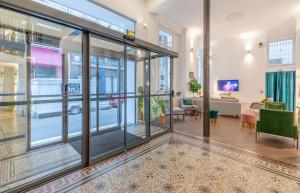 a lobby with glass doors and a living room at 1924 Hôtel in Grenoble