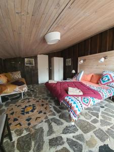 a large bed in a room with a wooden ceiling at Ranch du Haut-Languedoc in La Salvetat