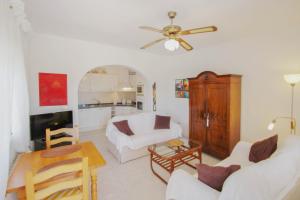 a living room with white furniture and a ceiling fan at Alma - holiday home with private swimming pool in Benitachell in Cumbre del Sol