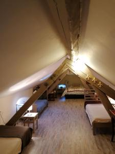 a attic room with beds and a staircase at aux coeurs de l'atelier in Menars