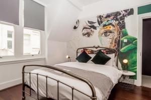 a bedroom with a bed with a mural on the wall at Hotel Nineteen in Brighton & Hove
