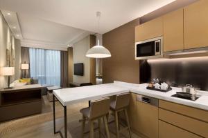 a kitchen with a table and chairs in a room at Hyatt House Shanghai Hongqiao CBD in Shanghai