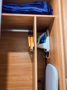a wooden cabinet with a bunch of tools in it at Apart-hotel Granja Brasil Itaipava in Itaipava