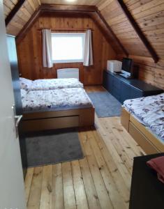 A bed or beds in a room at Chatky u potoka, chatička č. 1