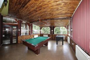 a pool table in a room with red walls at Villa Select in Predeal