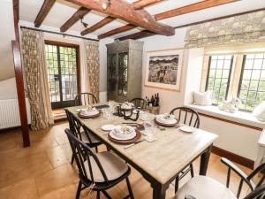 a dining room with a wooden table and chairs at The Small House in Cheltenham